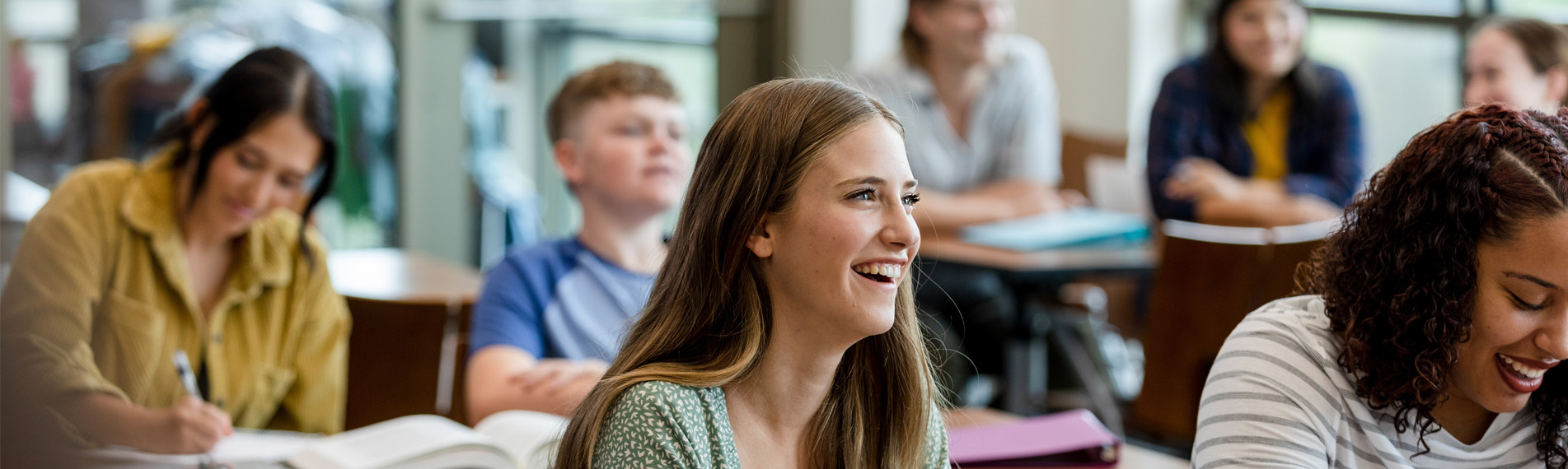 College students taking notes during class